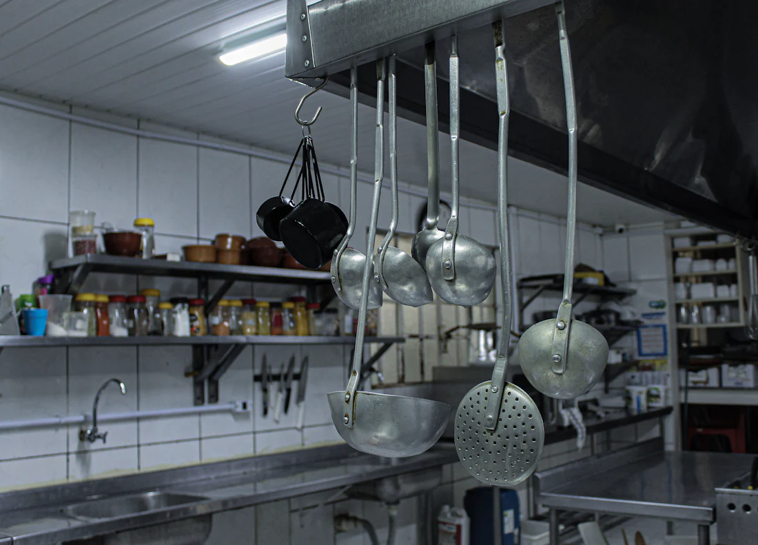 Ladles and pans hanging in a commercial kitchen